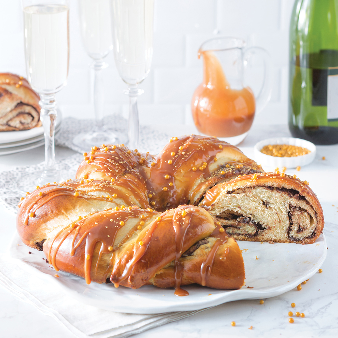 Salted Caramel and Chocolate King Cake - Louisiana Cookin' With rich chocolate and a smooth caramel sauce, who could resist this delicious king cake? Salted Caramel and Chocolate King Cake Serves: 1 Ingredients 6 tablespoons unsalted butter, softened ¼ cup sugar 2 teaspoons ground cinnamon King Cake Dough (recipe follows) 1 large egg 1 tablespoon water 2 (4-ounce) semisweet chocolate baking bars, chopped 