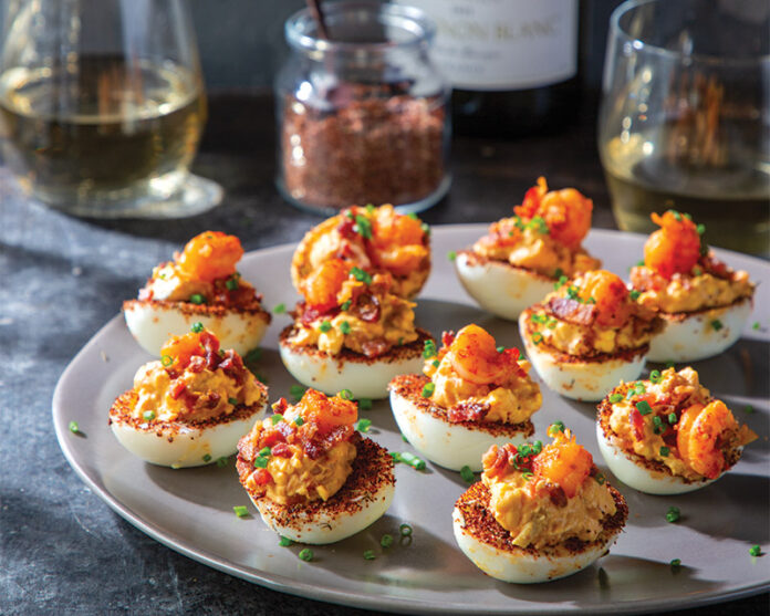 crawfish deviled eggs: These Cajun-kissed deviled eggs swap classic fillings for plump crawfish tails, a fiery kick, and a sprinkle of vibrant chives.