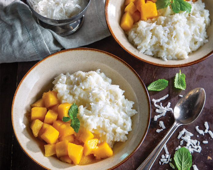 Dive into a bowl of Coconut Mango Sticky Rice Pudding! You’ll find creamy goodness with each spoonful of coconut-infused rice pudding and tangy mango slices.