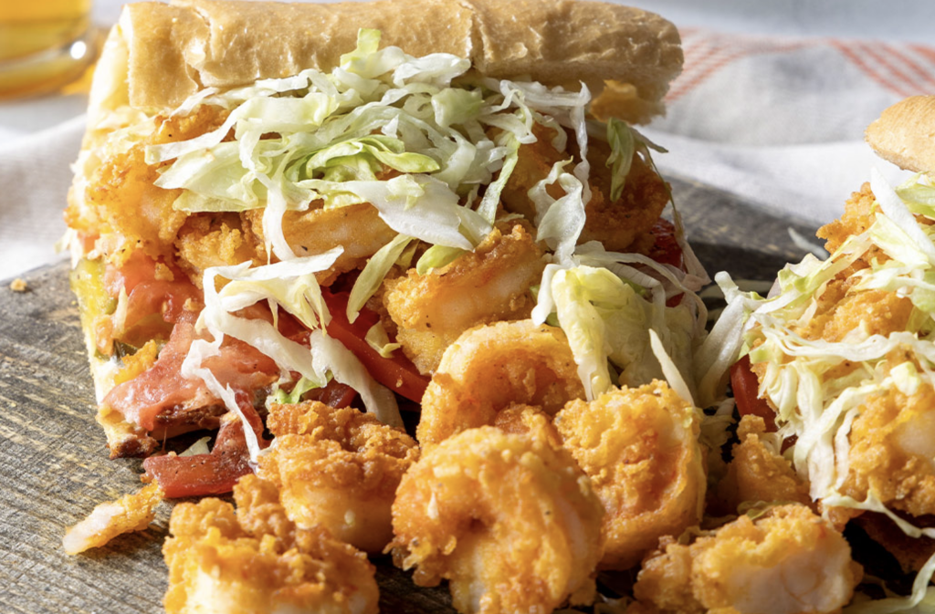 This fully dressed and overstuffed Shrimp Po’ Boy is a celebration of all things great out of the Bayou State! Succulent shrimp spill out of the bread, standing as a delicious reminder of Louisiana’s food culture: honoring plentiful and vibrant abundance.