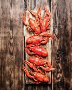 Weekend Away: Clarksdale, Mississippi - Louisiana Cookin' Set your sights on the Mississippi Delta for a soulful few days. Boiled crawfish arranged in a row on a wooden cutting board.
