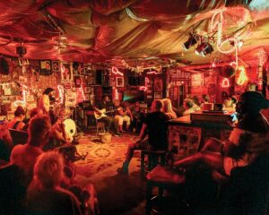 Weekend Away: Clarksdale, Mississippi - Louisiana Cookin' Set your sights on the Mississippi Delta for a soulful few days. Audience watching a small live band in a dimly lit bar with red lighting and posters on the walls.