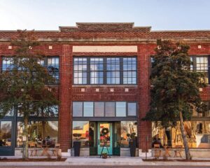 Weekend Away: Clarksdale, Mississippi - Louisiana Cookin' Set your sights on the Mississippi Delta for a soulful few days. Brick storefront with large grid windows and teal doors, flanked by two trees and outdoor seating along the sidewalk.