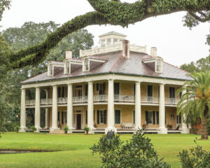 HoumasHouse_937JOH - Louisiana Cookin' Putting His Heart on the Plate: Inside Chef Jeremy Langlois’ Culinary Journey - Louisiana Cookin' Chef Jeremy Langlois reflects on his decades-long culinary journey—from training under legendary John Folse to Houma's House to his latest venture, a self-published cookbook. Two-story colonial mansion with a wraparound porch supported by tall white columns on a manicured lawn, surrounded by trees.