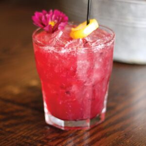 IMG_5571 - Louisiana Cookin' Making Waves: Louisiana’s Own Culinary Trailblazers - Louisiana Cookin' Louisiana-born chefs making their mark across the South. Bright pink cocktail with ice in a lowball glass, garnished with an orange twist and a pink flower