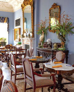 JeremyLanglois_191JOH - Louisiana Cookin' Putting His Heart on the Plate: Inside Chef Jeremy Langlois’ Culinary Journey - Louisiana Cookin' Chef Jeremy Langlois reflects on his decades-long culinary journey—from training under legendary John Folse to Houma's House to his latest venture, a self-published cookbook. Opulent dining room with blue walls, gold-framed mirrors, and ornate wooden chairs around marble-topped tables.